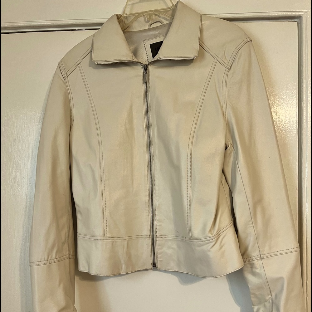 Used leather jacket, cream in color. No outer pockets.